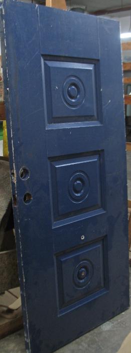 Door With Circles In Three Center Panels Painted Blue Before Stripping