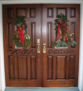 Refinished Pair Of Front Doors With Christmas Wreaths